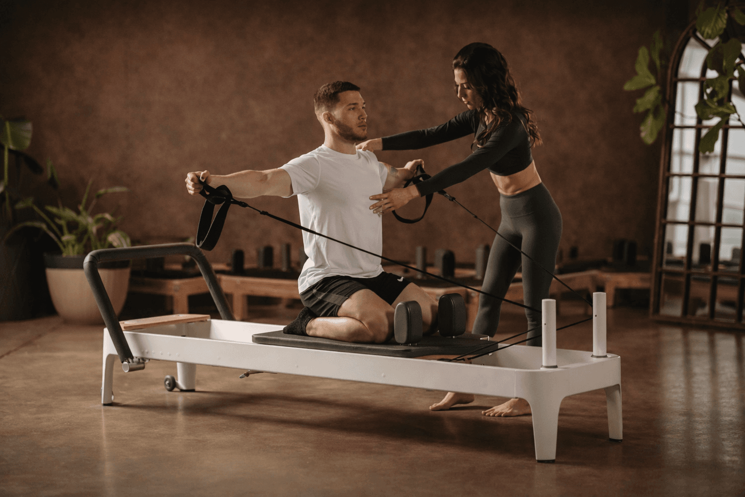Person performing reformer & mat Pilates movement